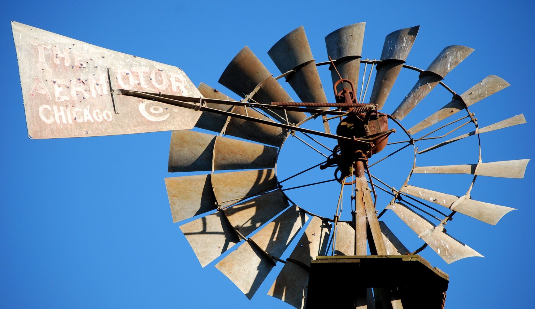 Vintage farm windmill against a blue sky near Appellation Petaluma in Sonoma County wine country