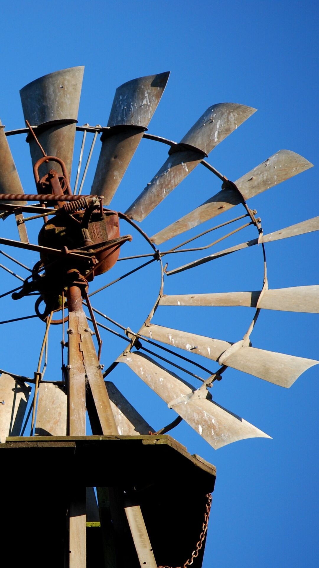 Vintage farm windmill against a blue sky near Appellation Petaluma in Sonoma County wine country